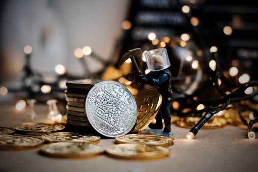 Digital currency physical metal coin. Christmas cryptocurrency concept.