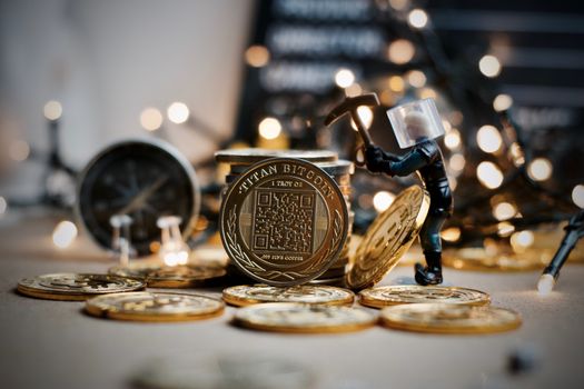 Digital currency physical metal coin. Christmas cryptocurrency concept.