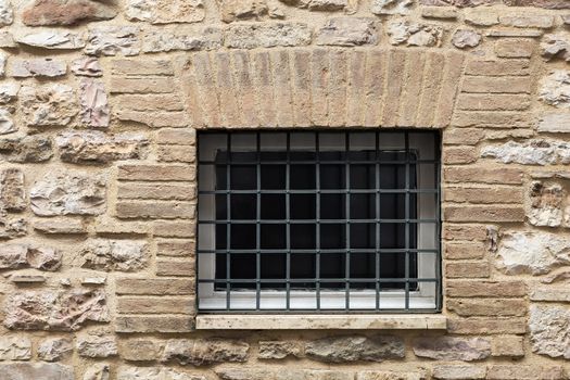 Assisi (Italy): Window on medieval stone wall