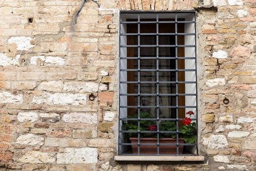 Assisi (Italy): Window on medieval stone wall