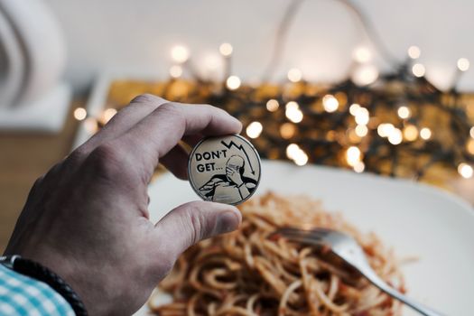 Digital currency physical metal bitcoin coin. Restaurant pasta concept.