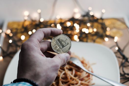 Digital currency physical metal gold litecoin coin. Italian food concept.