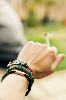 Small spliff in man hand. Marijuana smoking concept.