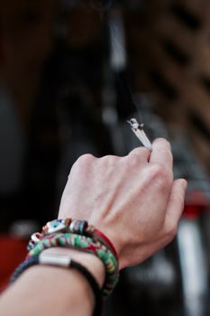 Small spliff in man hand. Marijuana smoking concept.