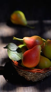 Pears in a basket on wooden table