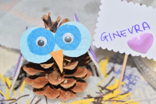 close up of an owl shaped pine cone