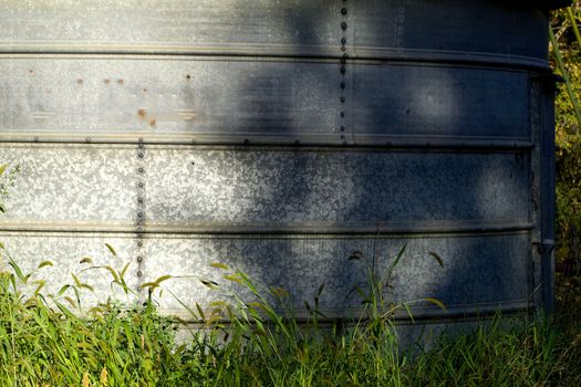 Galvanized bin in the green grass