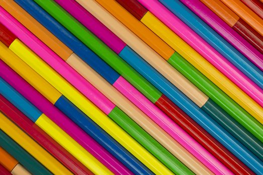 Collection of coloured pencils in a diagonal line pattern as background picture

