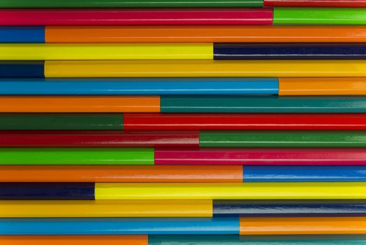Collection of coloured pencils in a horizontal complementary colors set up as background picture
