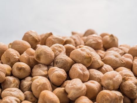 Extreme close up view of raw chickpea on gray concrete background