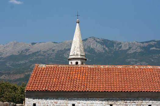 Sharp rooftop of the church tower hidden by roof, Montenegro Budva