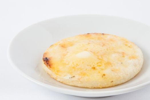 Traditional Colombian arepa topped with melted butter