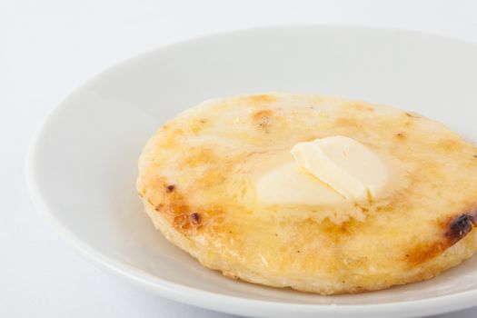 Traditional Colombian arepa topped with melted butter