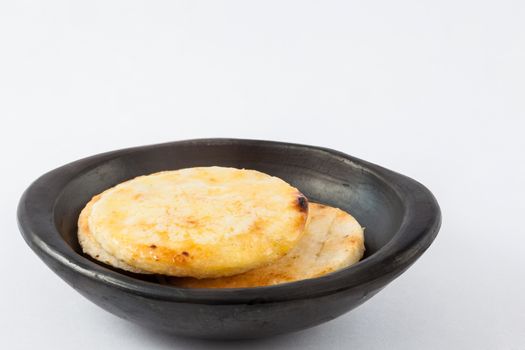 Traditional Colombian arepa topped with melted butter