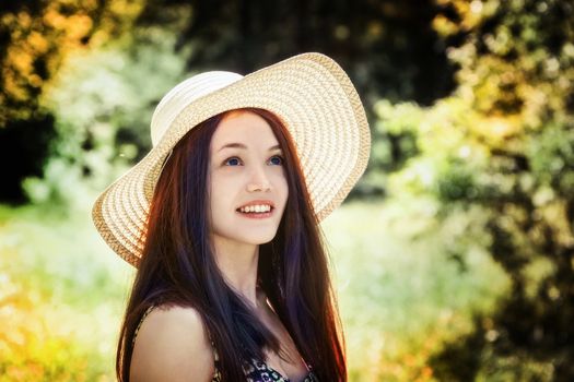 beautiful young brunette woman on the meadow on a warm summer day