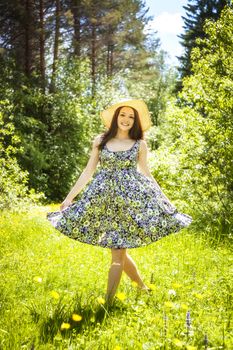 beautiful young brunette woman on the meadow on a warm summer day