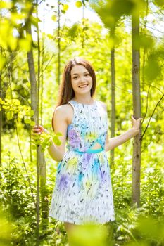 beautiful young brunette woman on the meadow on a warm summer day