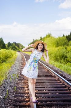 beautiful young brunette woman on the meadow on a warm summer day