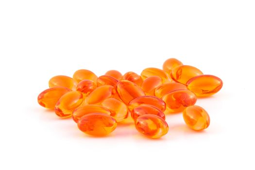 orange dha pill heap isolated on white background