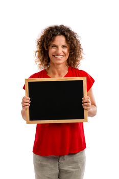 Portrait of a smiling middle aged brunette holding a chalkboard