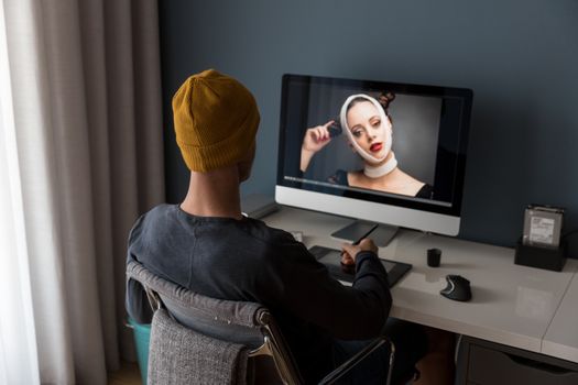 Man working at home editing pictures on computer