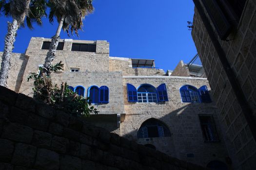 View of a traditional house. Stone walls, blue windows and shutters reflect the architectural style of the region.