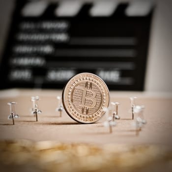 Digital currency physical metal bitcoin coin. Cryptocurrency cinema concept.