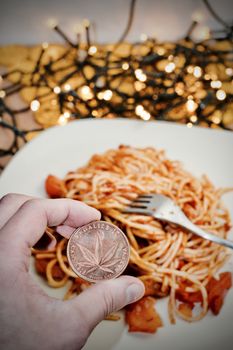 Brass marijuana coin with leaf. Italian pasta food concept.