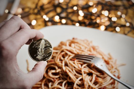 Digital currency physical gold feather coin. Italian pasta food concept.