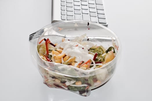 Eat near computer keyboard. Delicious fresh salad with mayo.