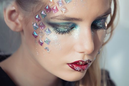 Fashion makeup. Woman with colorful makeup and body art.