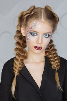 Fashion makeup. Woman with colorful makeup and body art.