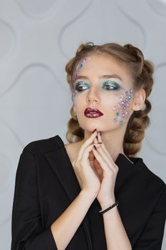 Fashion makeup. Woman with colorful makeup and body art.