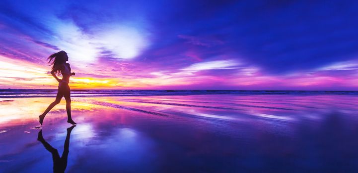 Woman in bikini running on the beach at sunset. Bali island, Indonesia