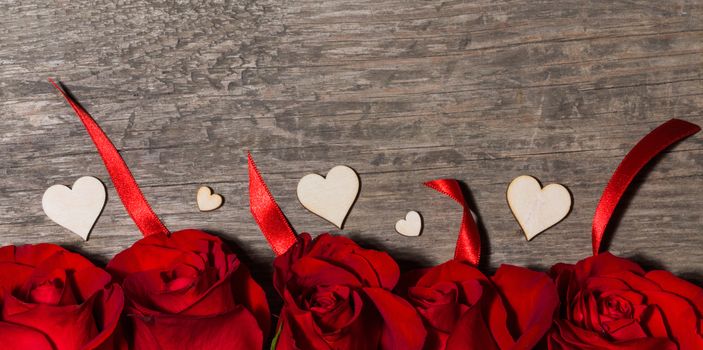 Roses and hearts on wooden background for Valentines day
