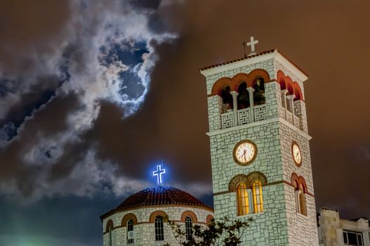 heavy rain is coming above a christian church