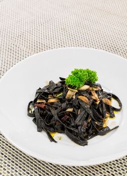 Fresh black aglio olio pasta with garlic and chilli