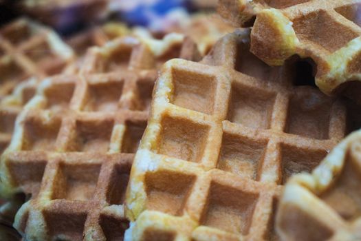 A group of waffles bacground disposed in a bakery