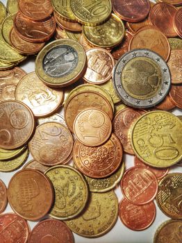 A group of euro coins disposed on a white background