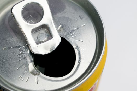 A close up photo of a open can on a white background