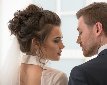 Groom and bride looking each to other at the wedding day