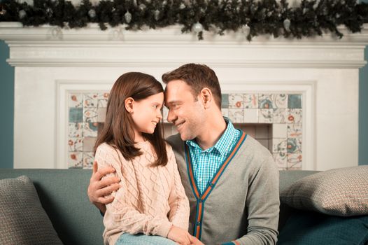 Family portrait of happy father and his daughter at home