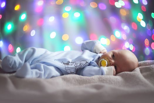 Cute newborn baby portrait on magic lights bokeh background
