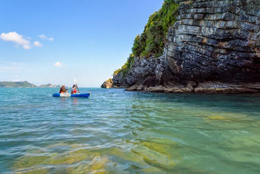 Two women are mother and daughter. Travel by boat with a kayak happy under the blue sky summer around Ko Phi view the beautiful nature of the sea and island, Mu Ko Ang Thong National Park, Surat Thani, Thailand