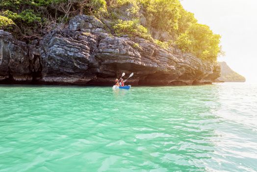 Two women are mother and daughter. Travel by boat with a kayak on the sea under sunlight at summer around Ko Phi enjoy the beautiful nature of the sea and island, Mu Ko Ang Thong National Park, Surat Thani, Thailand