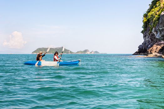 Two women are mother and daughter. Travel by boat with a kayak happy under the blue sky summer around Ko Phi view the beautiful nature of the sea and island, Mu Ko Ang Thong National Park, Surat Thani, Thailand