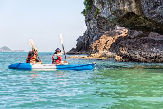 Two women are mother and daughter. Travel by boat with a kayak happy under the blue sky summer around Ko Phi view the beautiful nature of the sea and island, Mu Ko Ang Thong National Park, Surat Thani, Thailand