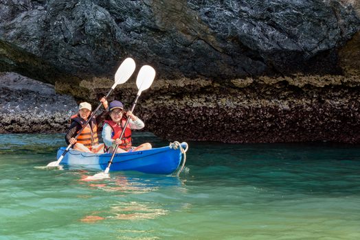 Two women are mother and daughter. Travel by boat with a kayak happy under the blue sky summer around Ko Phi view the beautiful nature of the sea and island, Mu Ko Ang Thong National Park, Surat Thani, Thailand