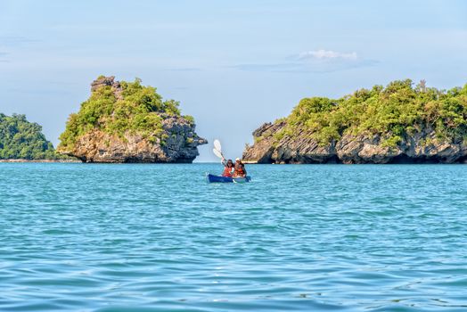 Two women are mother and daughter. Travel by boat with a kayak around island enjoy view the beautiful natural landscape of the blue sea at summer, Mu Ko Ang Thong National Park, Surat Thani, Thailand