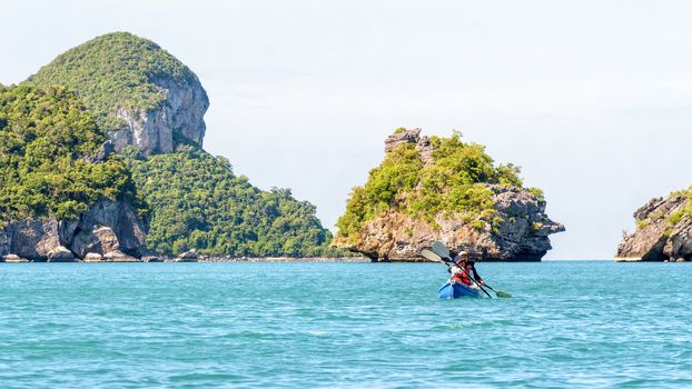 Two women are mother and daughter. Travel by boat with kayak view the beautiful natural landscape of the blue sea and island at summer, Mu Ko Ang Thong National Park, Surat Thani, Thailand, 16:9 widescreen